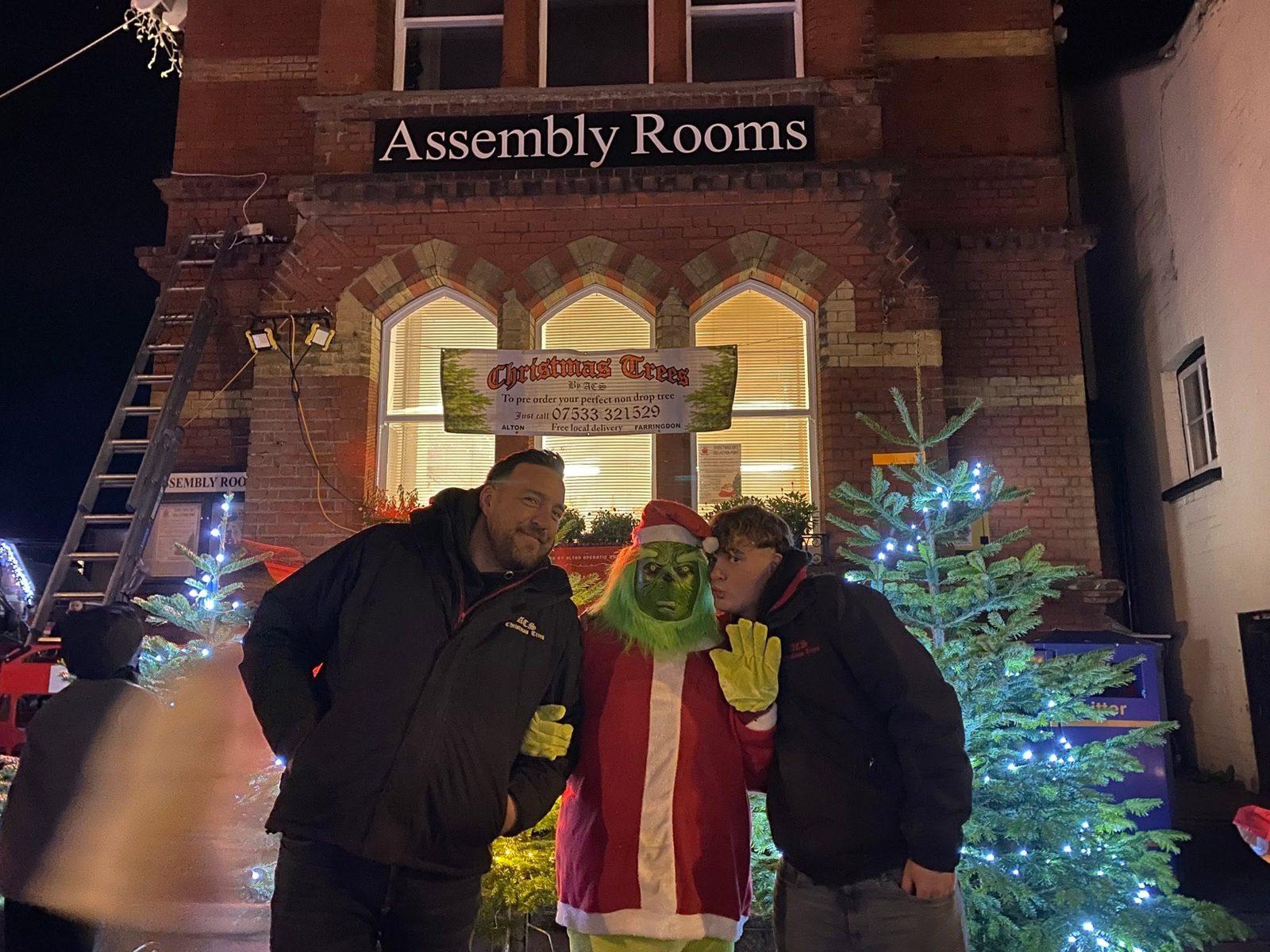 The ACS team with the Grinch outside the Assembly Rooms at night